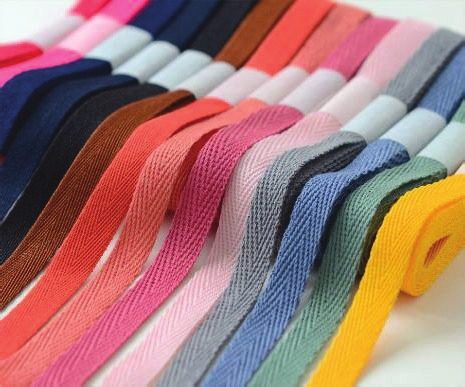 Colourful twill tape rolls stacked diagonally
